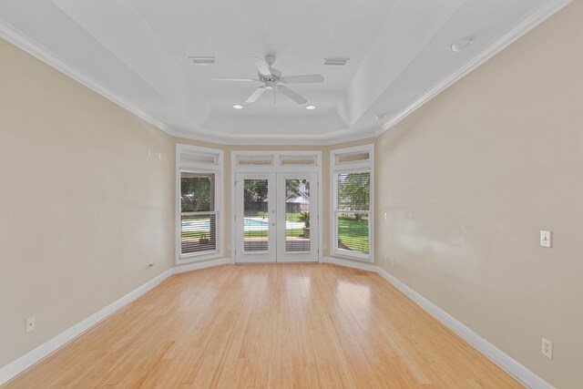 707 Edinburgh Way, Dothan, AL 36305 - unfurnished room featuring a ceiling fan, french doors, baseboards, light wood-style floors, and a tray ceiling