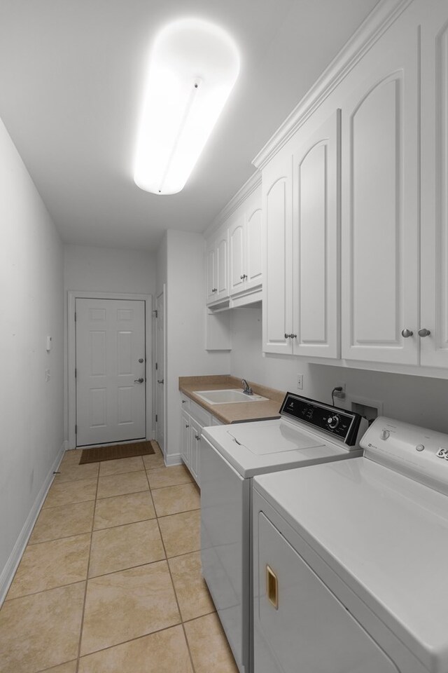 707 Edinburgh Way, Dothan, AL 36305 - washroom with independent washer and dryer, light tile patterned flooring, cabinet space, a sink, and baseboards