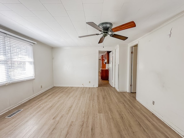 unfurnished room featuring baseboards, visible vents, ceiling fan, and light wood finished floors