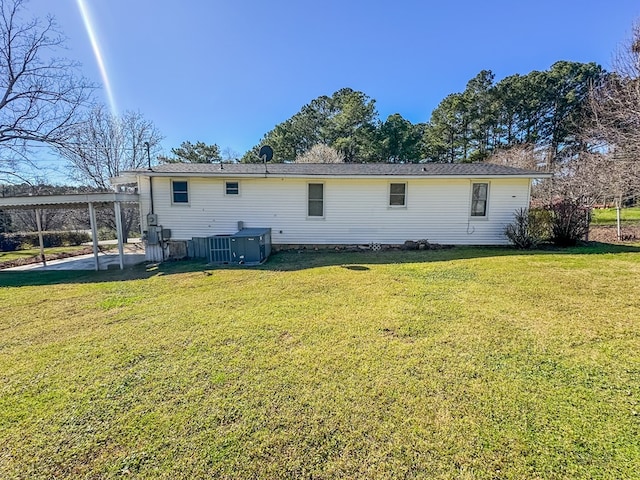 back of property with a yard and central air condition unit