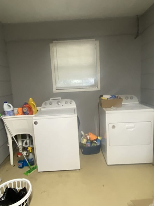 clothes washing area with washing machine and clothes dryer