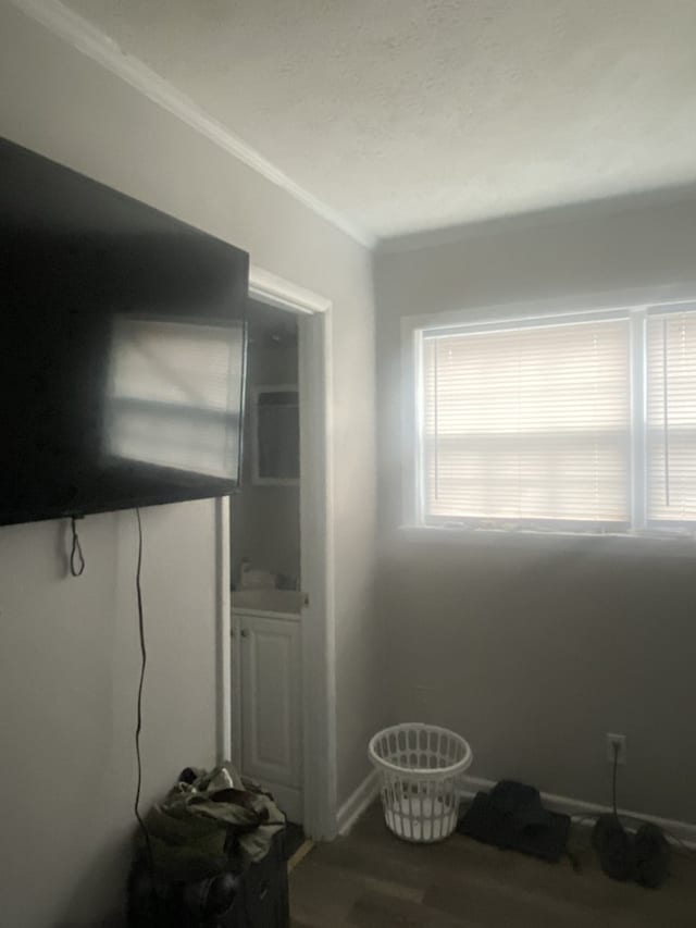 interior space featuring wood-type flooring and crown molding