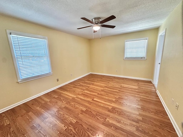 1006 Northfield Cir, Dothan, AL 36301 - empty room with light wood finished floors, ceiling fan, a textured ceiling, and baseboards