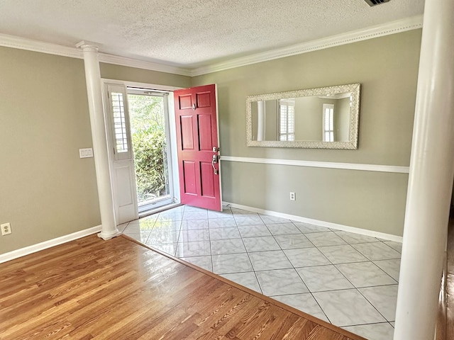 1006 Northfield Cir, Dothan, AL 36301 - foyer featuring decorative columns, a textured ceiling, wood finished floors, baseboards, and crown molding