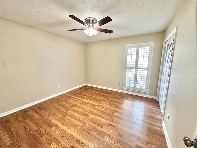 1006 Northfield Cir, Dothan, AL 36301 - spare room with light wood-type flooring, baseboards, a ceiling fan, and a textured ceiling