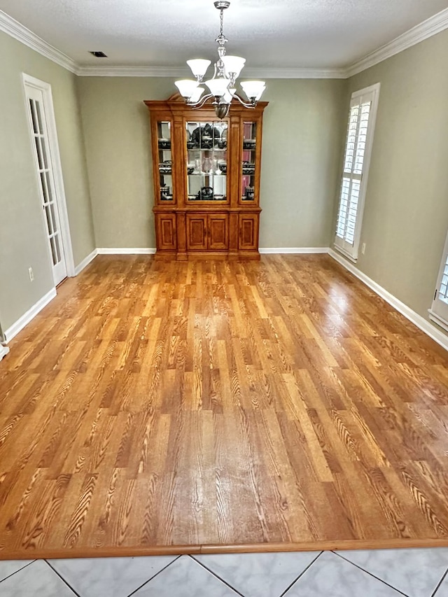 1006 Northfield Cir, Dothan, AL 36301 - unfurnished dining area featuring a chandelier, light wood-style floors, ornamental molding, and baseboards