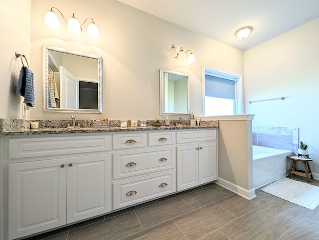 bathroom with vanity and a bathtub