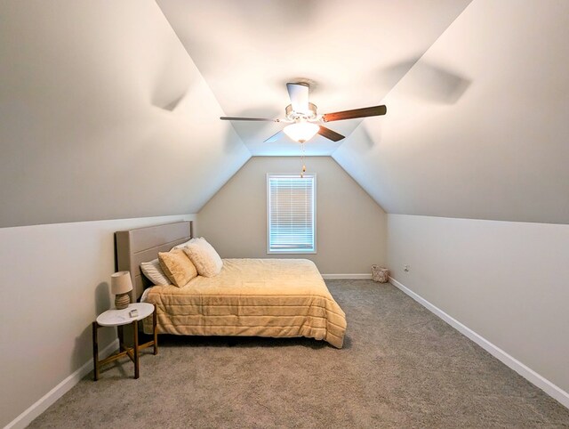 bedroom with ceiling fan, carpet floors, and vaulted ceiling