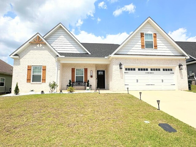 view of front facade with a porch, a garage, and a front lawn