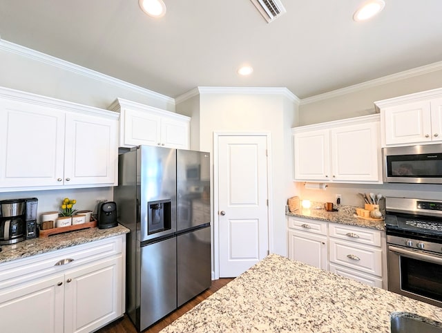 kitchen with crown molding, white cabinets, dark wood-type flooring, and appliances with stainless steel finishes