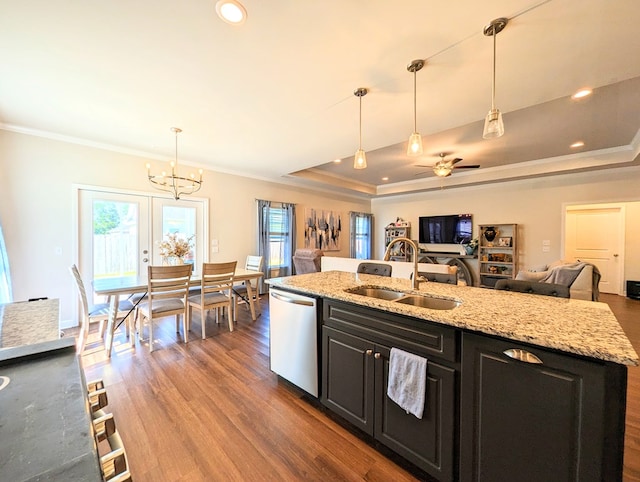 kitchen featuring ceiling fan with notable chandelier, stainless steel dishwasher, hanging light fixtures, and light stone counters