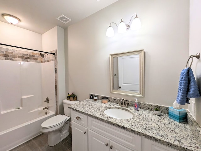 full bathroom featuring washtub / shower combination, vanity, and toilet