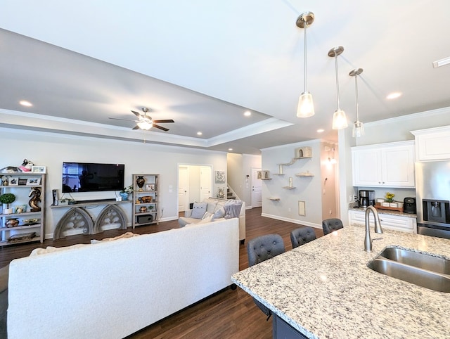 kitchen with white cabinets, dark hardwood / wood-style flooring, hanging light fixtures, and sink