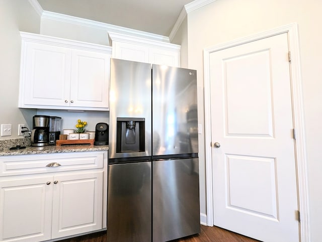 kitchen featuring stainless steel fridge with ice dispenser, white cabinetry, and crown molding