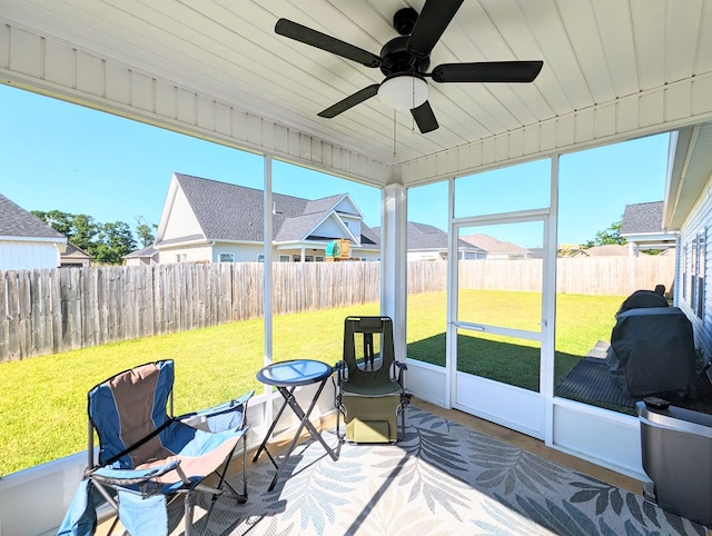 sunroom featuring ceiling fan