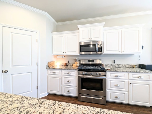 kitchen featuring white cabinets, appliances with stainless steel finishes, dark hardwood / wood-style flooring, and crown molding