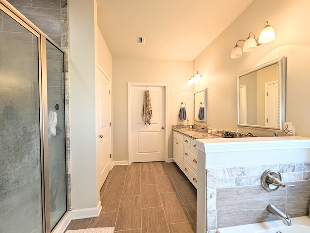 bathroom featuring vanity and an enclosed shower