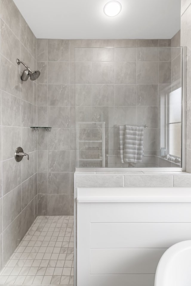 bathroom with a tile shower