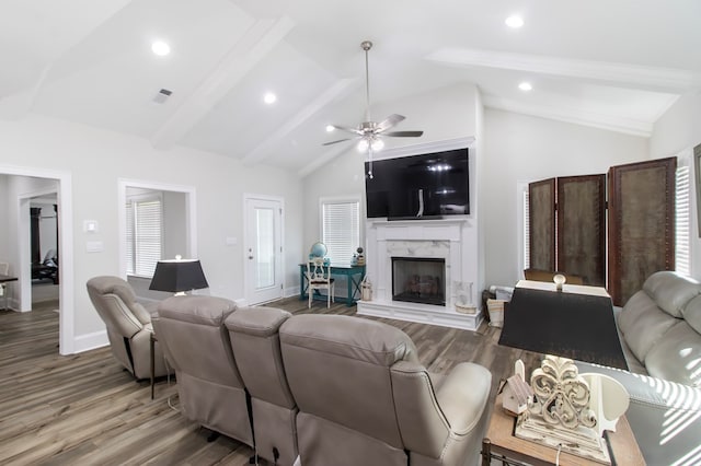 living room with high vaulted ceiling, beamed ceiling, ceiling fan, a premium fireplace, and hardwood / wood-style floors