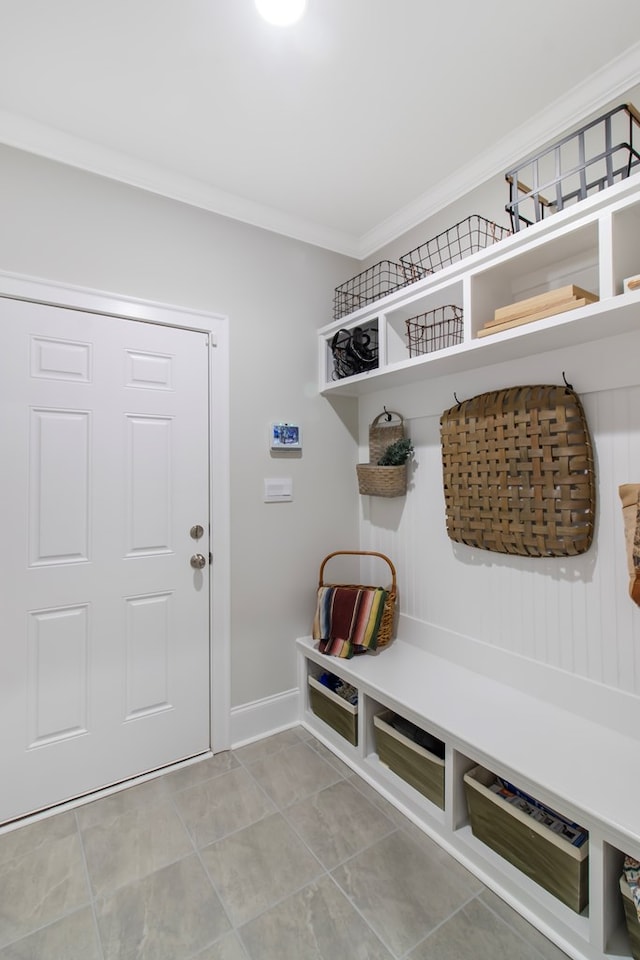 mudroom featuring crown molding and light tile patterned flooring