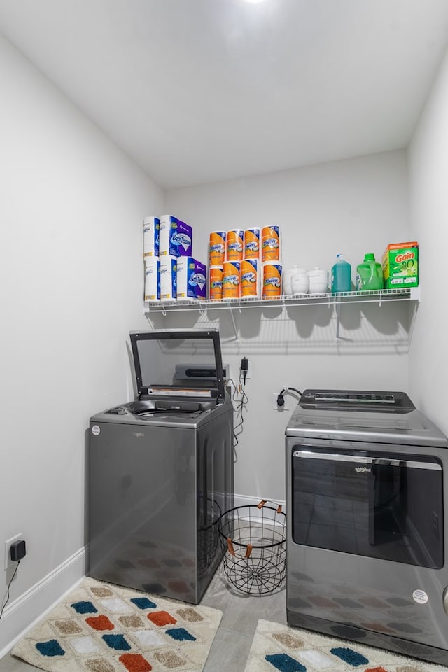 clothes washing area featuring independent washer and dryer