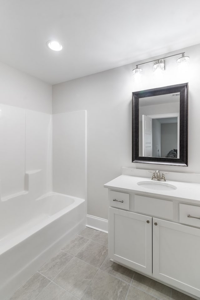 bathroom with tile patterned flooring, bathing tub / shower combination, and vanity