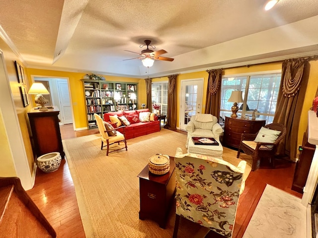 508 N Englewood Ave, Dothan, AL 36303 - living room featuring hardwood / wood-style floors, a textured ceiling, ceiling fan, a raised ceiling, and ornamental molding