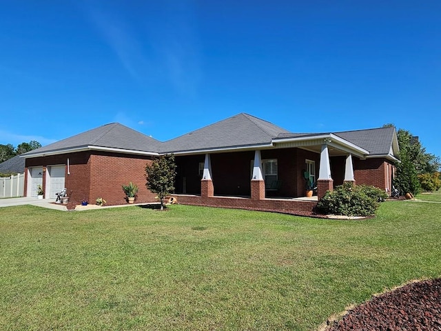 view of front facade featuring covered porch, a garage, and a front yard