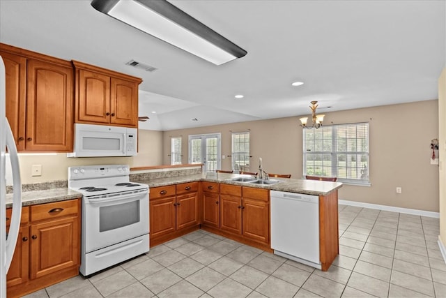 4808 Crystal Springs Rd, Red Level, AL 36474 - kitchen featuring a peninsula, a sink, visible vents, white appliances, and brown cabinets