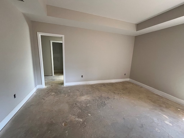 unfurnished room featuring a tray ceiling