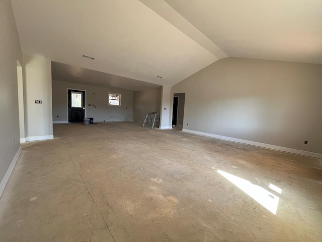 unfurnished living room with vaulted ceiling