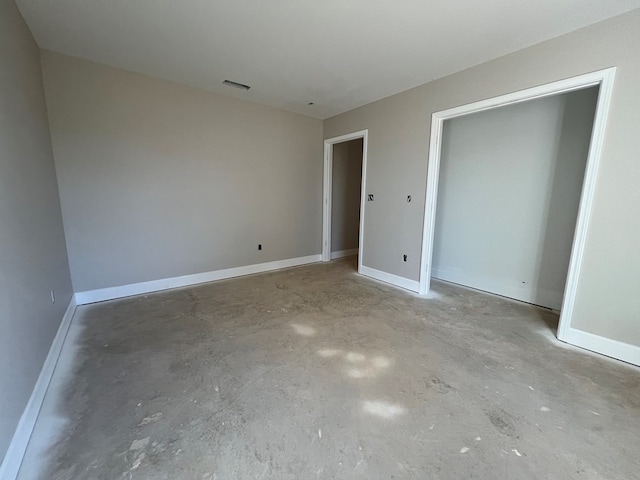 unfurnished bedroom featuring concrete flooring