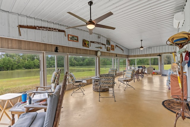 sunroom / solarium featuring outdoor dining space, a ceiling fan, a water view, and an AC wall unit