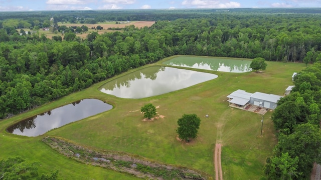 aerial view with a water view and a forest view