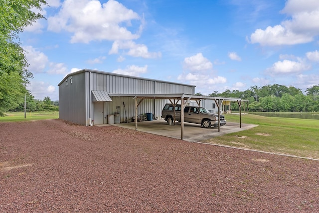 view of car parking with a carport and a water view