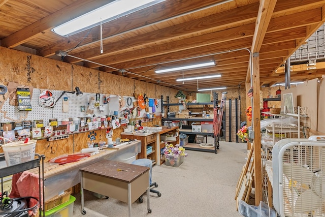 interior space featuring carpet and a workshop area