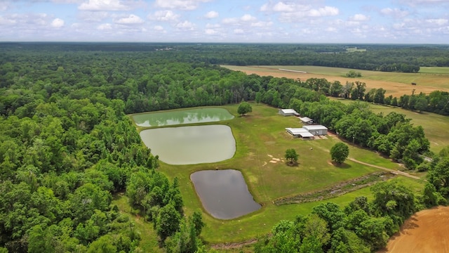 aerial view with a wooded view and a water view