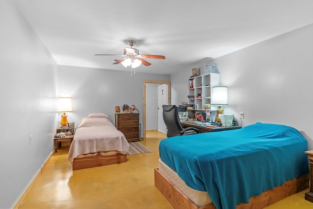 bedroom with a ceiling fan, concrete flooring, and baseboards