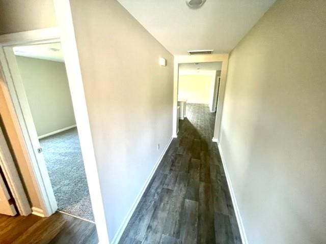 corridor featuring dark wood-type flooring