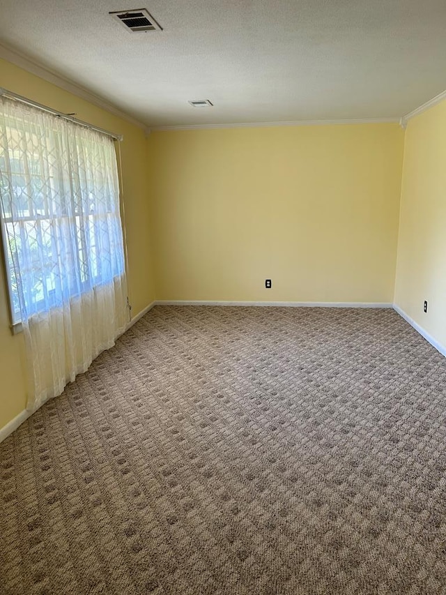 carpeted empty room featuring a textured ceiling and ornamental molding