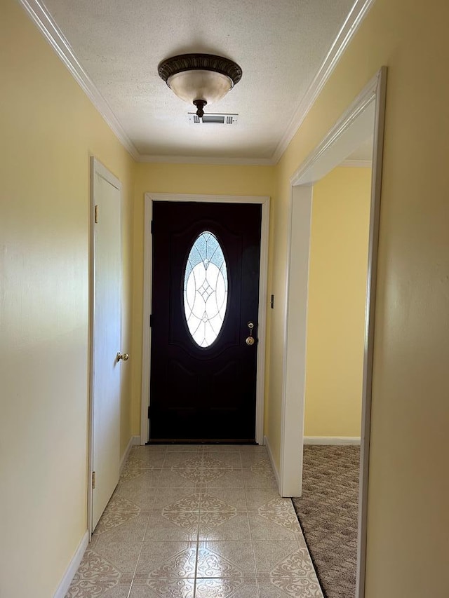 doorway to outside with a textured ceiling and crown molding