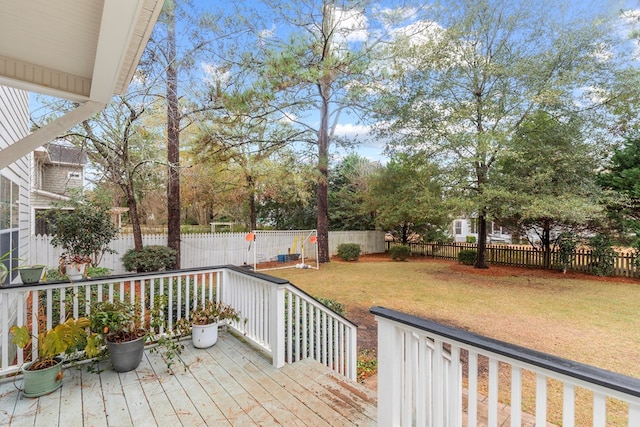 wooden terrace featuring a yard