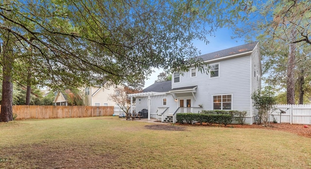 back of house with a pergola and a yard