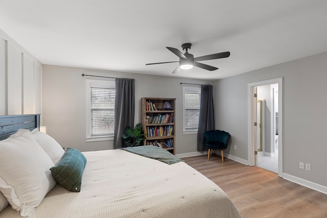 bedroom featuring ensuite bath, ceiling fan, and light hardwood / wood-style flooring