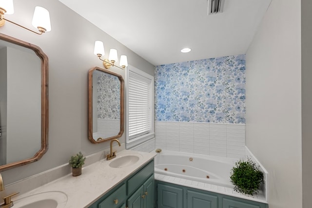 bathroom with a washtub and vanity