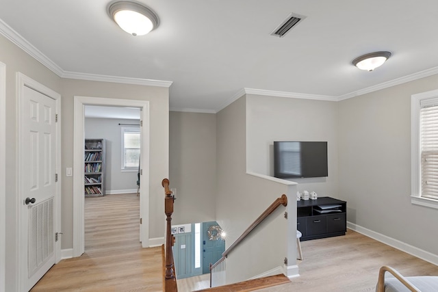 hallway featuring light wood-type flooring and crown molding