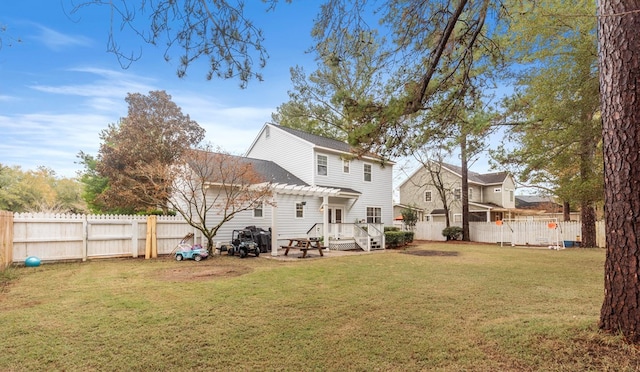 back of property with a pergola and a lawn