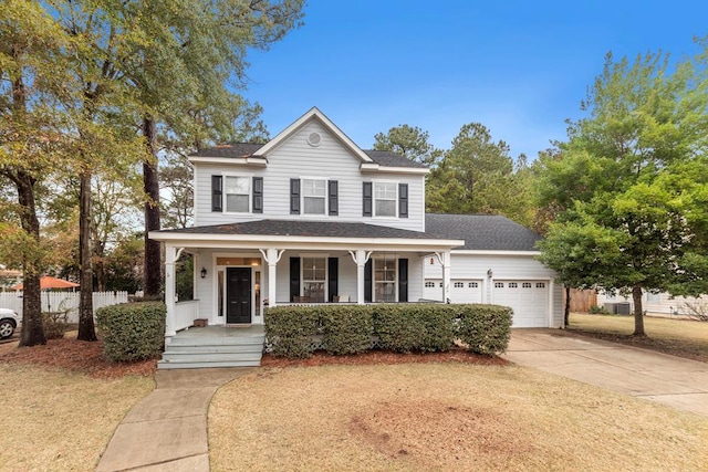 view of front of house featuring covered porch, a front lawn, and a garage