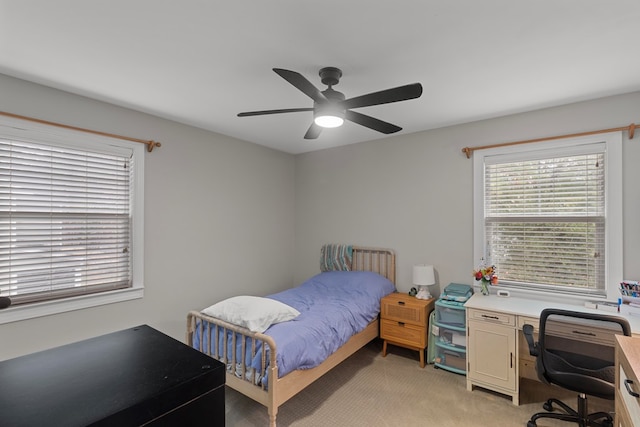 bedroom with light carpet and ceiling fan