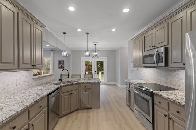 kitchen featuring sink, french doors, light wood-type flooring, decorative backsplash, and appliances with stainless steel finishes